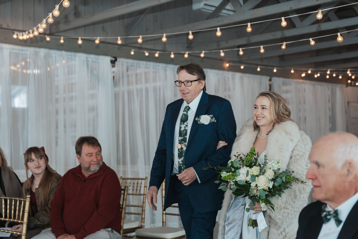 Bride walks down the aisle hand in hand with her father 