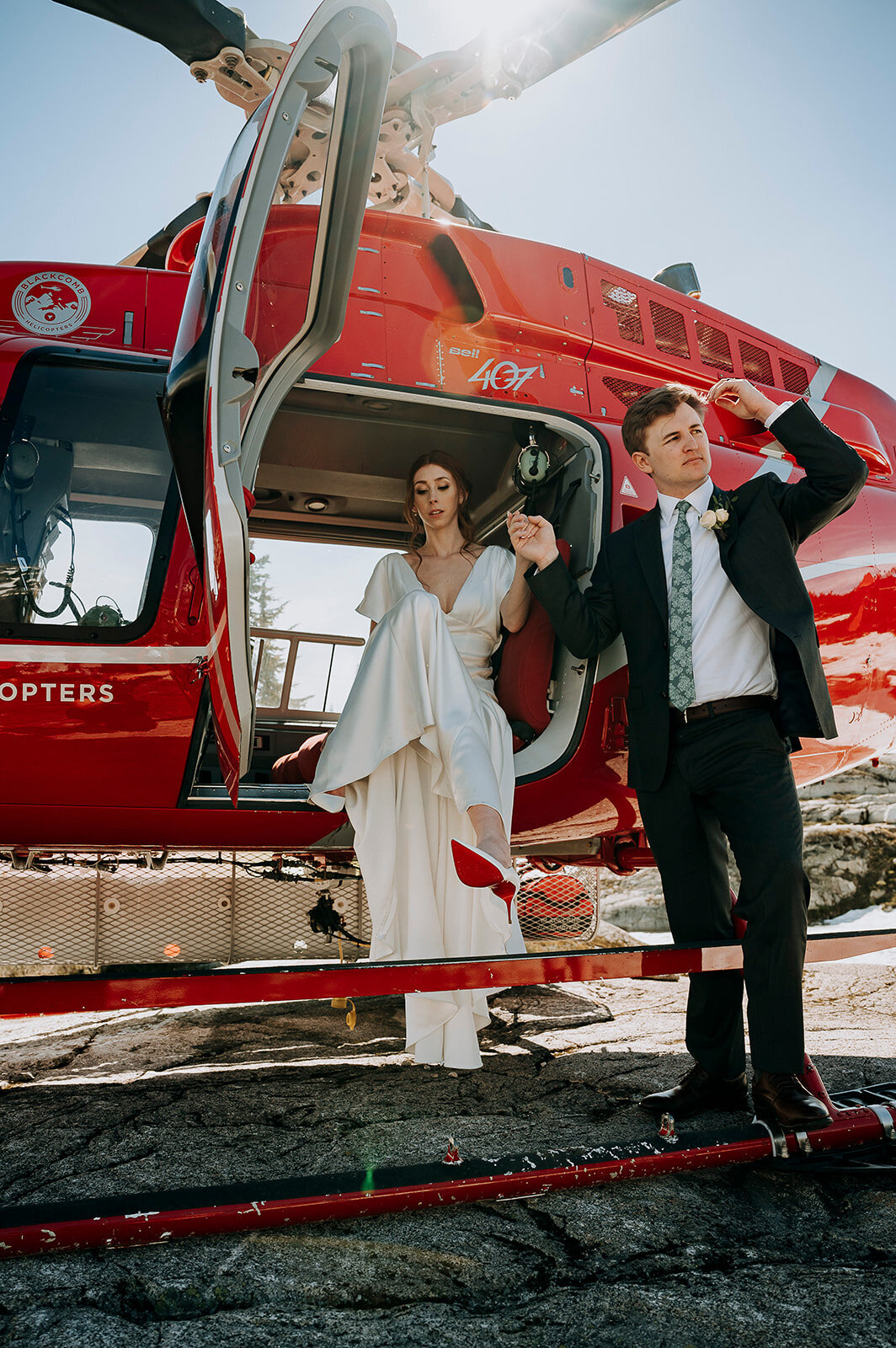 Whistler wedding couple steps out of a Blackcomb Helicopter at Beverly Lake for their alpine elopement ceremony