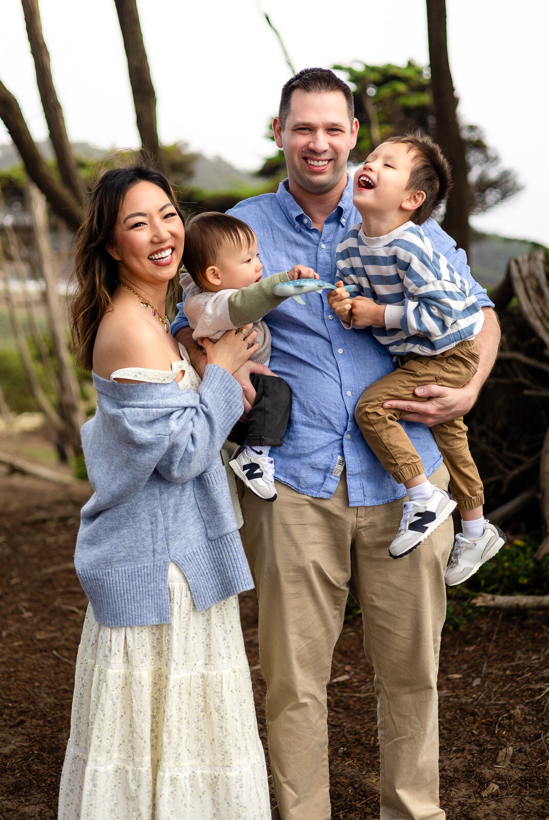 Family of four in a joyful candid embrace with Bay Area Family Portfolio – Ellobelle Photography