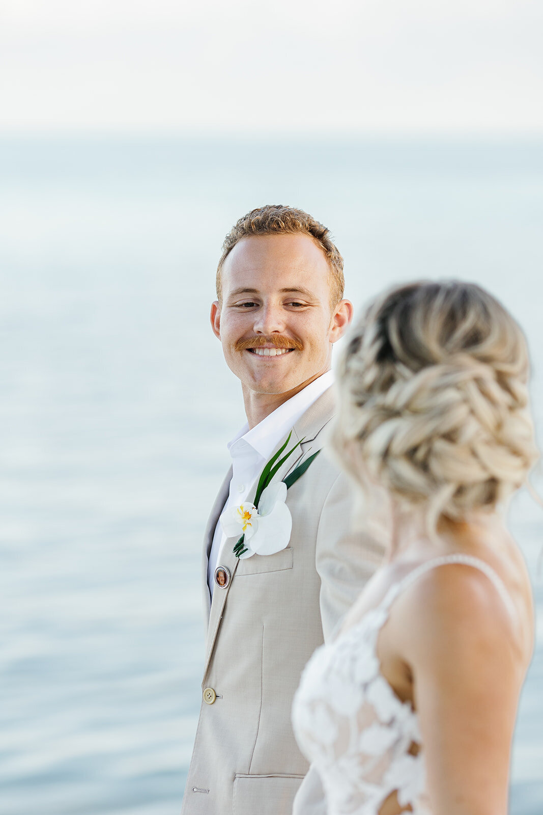 Hunter smiles warmly as he admires Ashley by the water’s edge.
