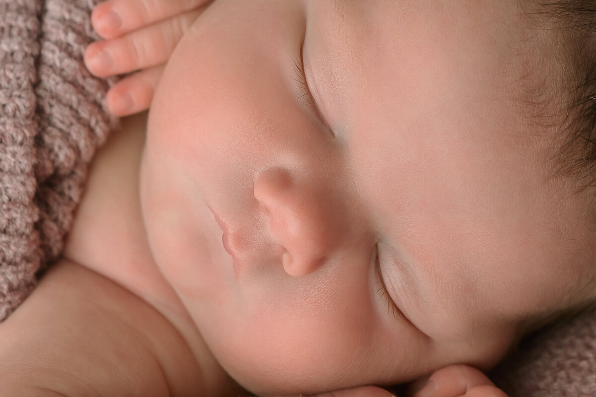 Details of a sleeping newborn's face up close