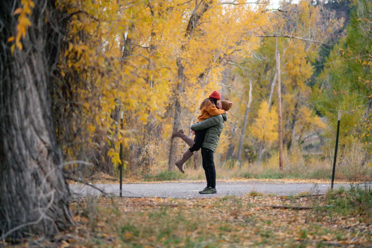 Colorado elopement with Asian couple fall foliage yellow leaves color and kiss.