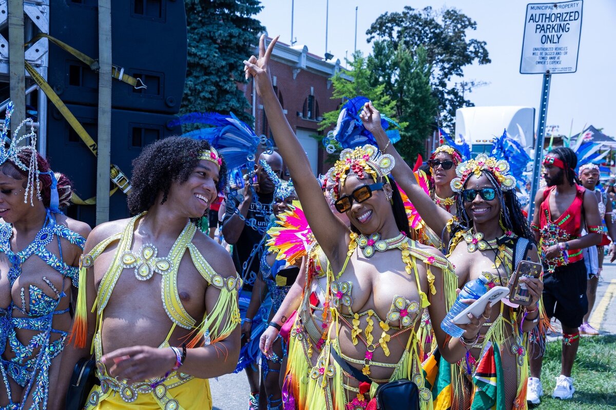 Toronto caribbean carnival parade masquerader in costume with Sunlime Mas, the number 1 medium size band at Toronto Carnival.