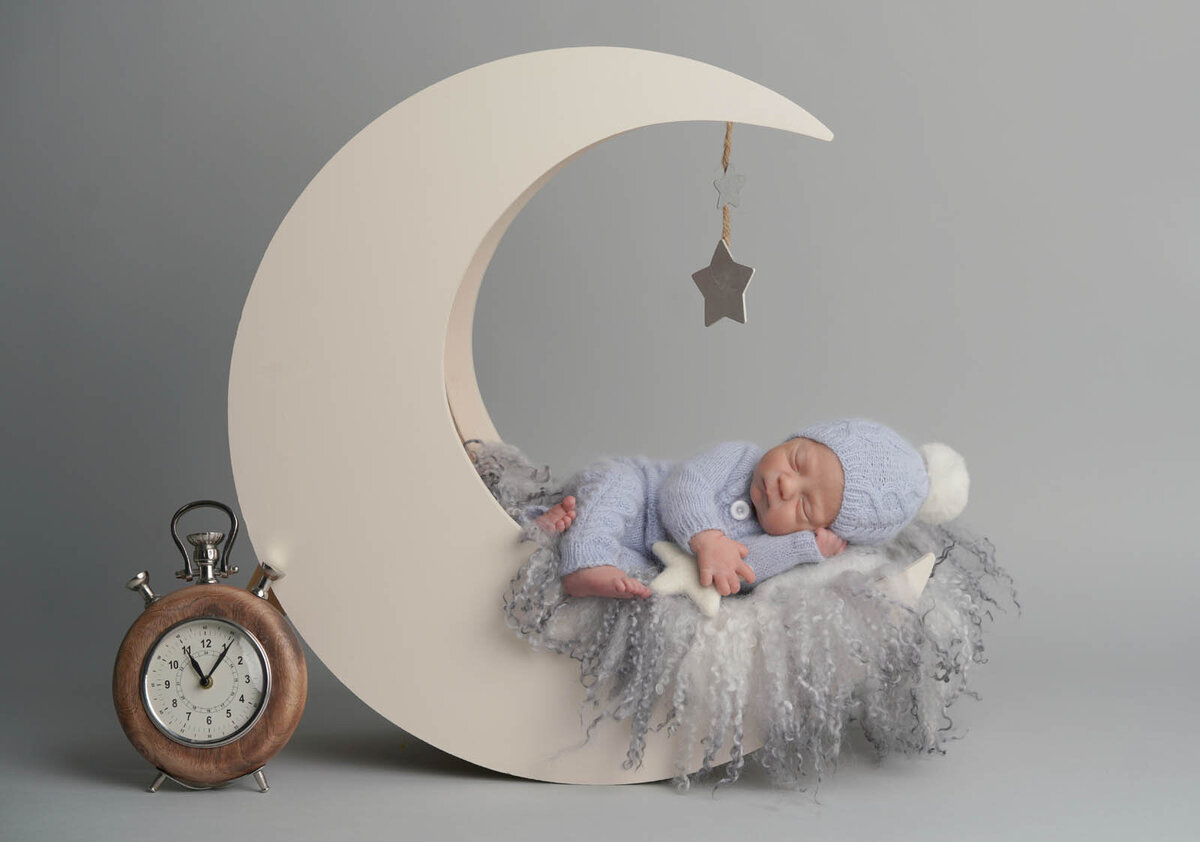 Newborn sleeping on a mini crescent moon