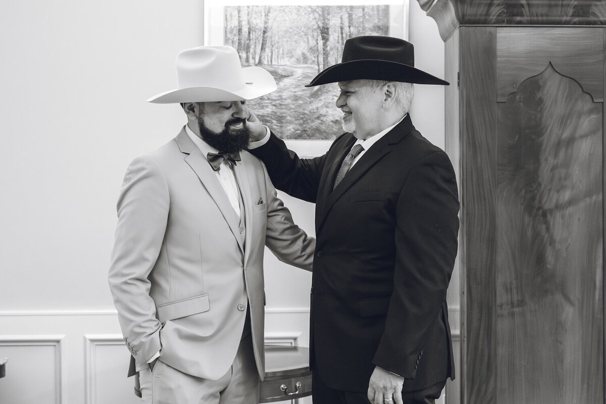 Groom and father figure sharing a moment before ceremony