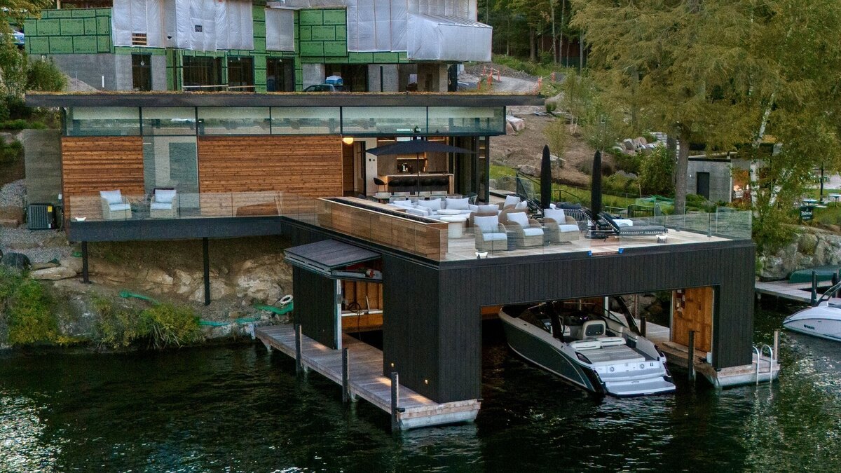 outside view of boat house with lounge deck and main home still under construction