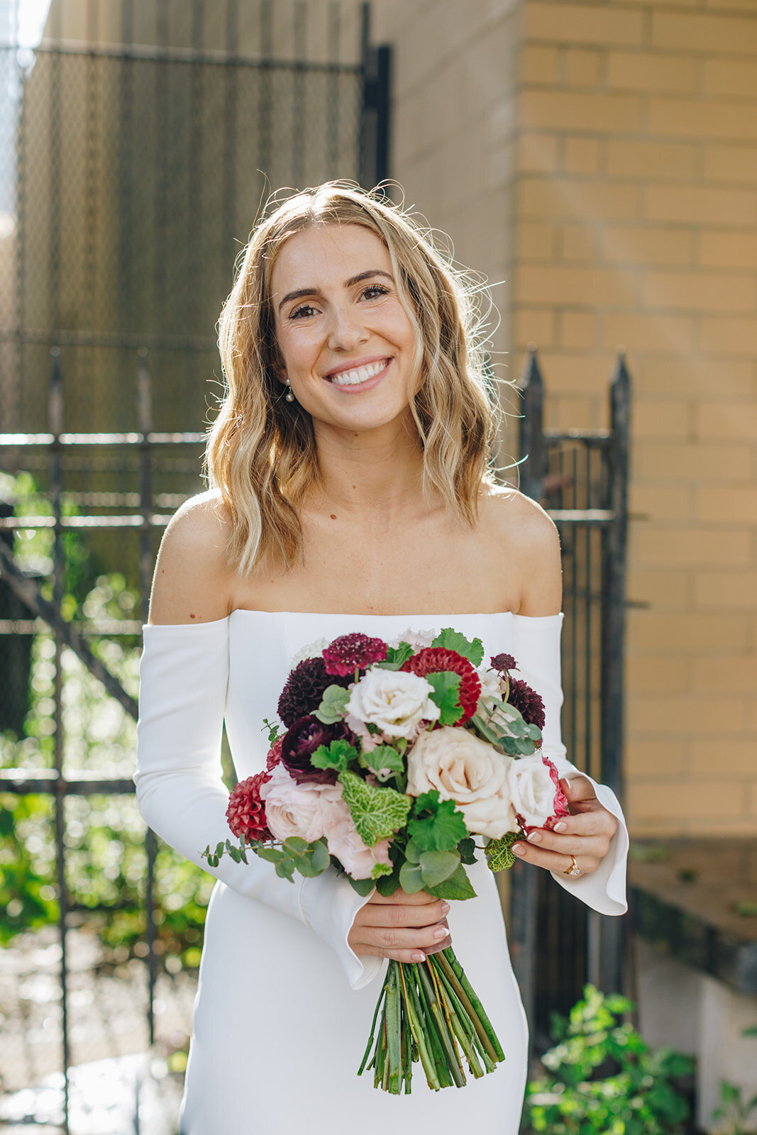 bride and her wedding bouquet in the sunlight
