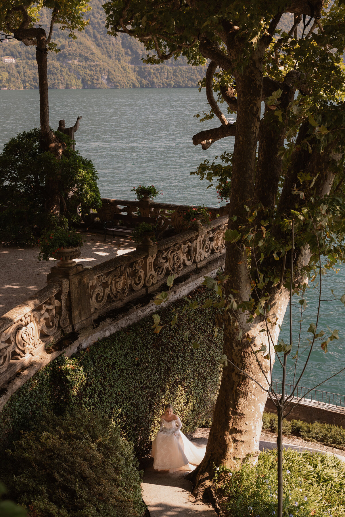 Wedding photographer captures couple taking a stroll hand in hand at their french chateau wedding.