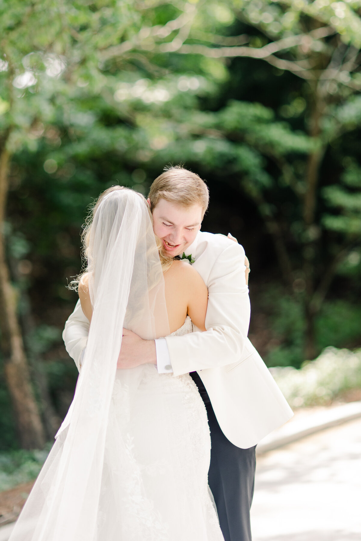 Groom and bride embracing at their first look