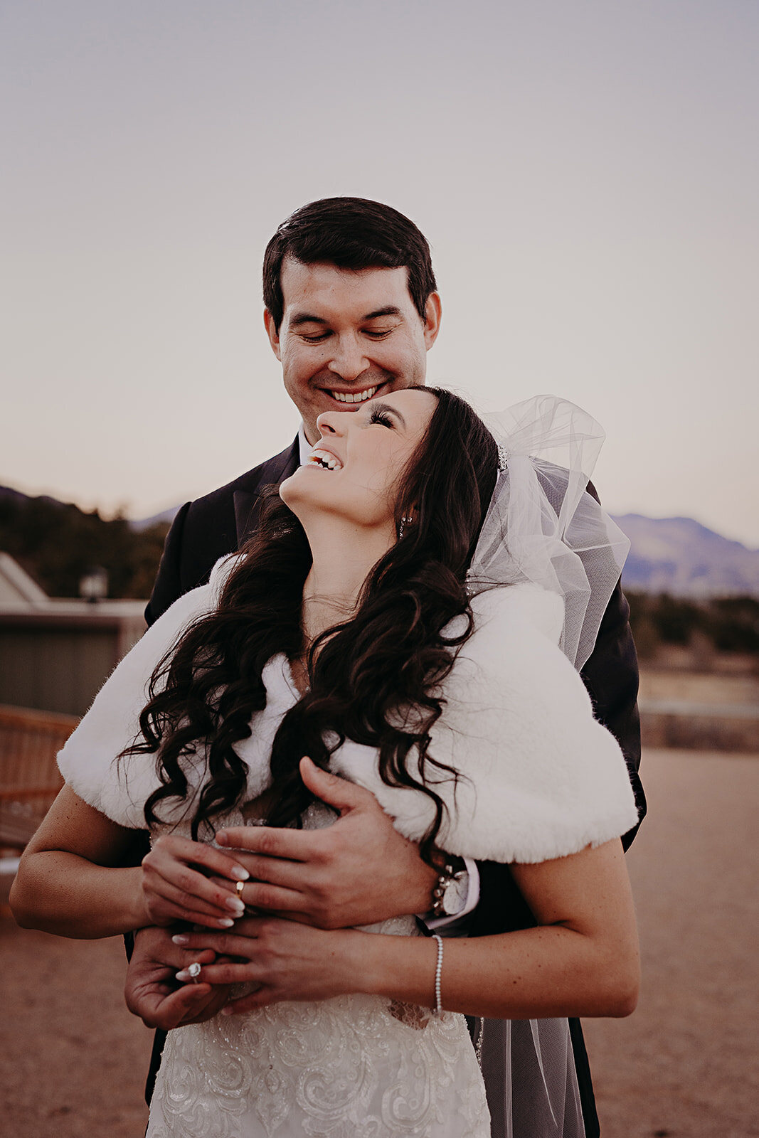 Bride and groom portrait featuring  their wedding rings.