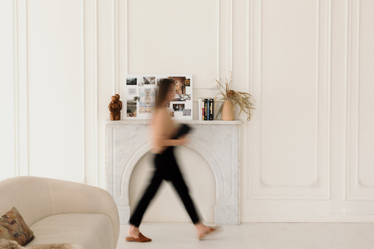 creative photo, woman walking past chairs in office