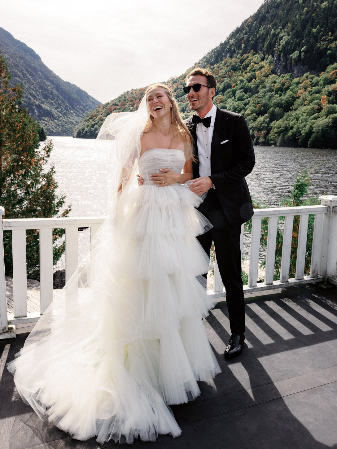 adirondack-mountain-wedding-10-elegant-couple-portrait-on-balcony-with-mountain-lake-background-at-adirondack-mountain-wedding-jenny-fu-studio