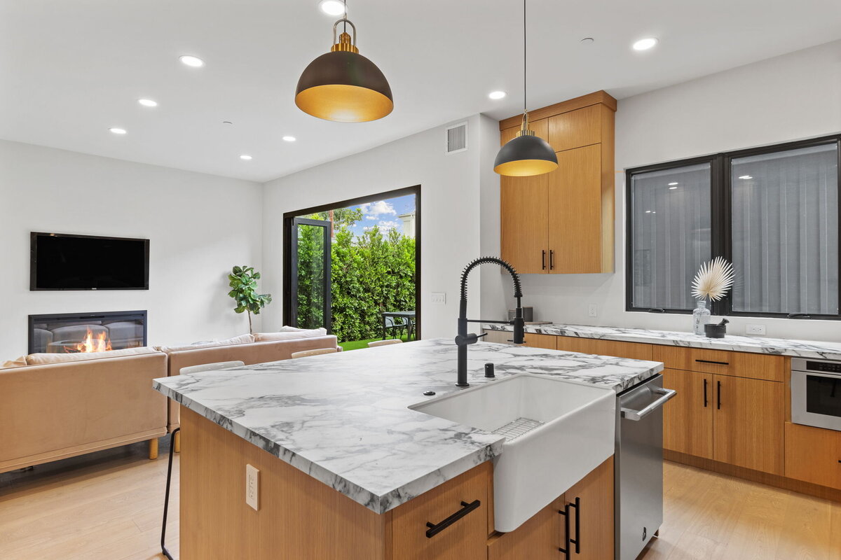 modern-kitchen-open-layout-marble-island-fireplace