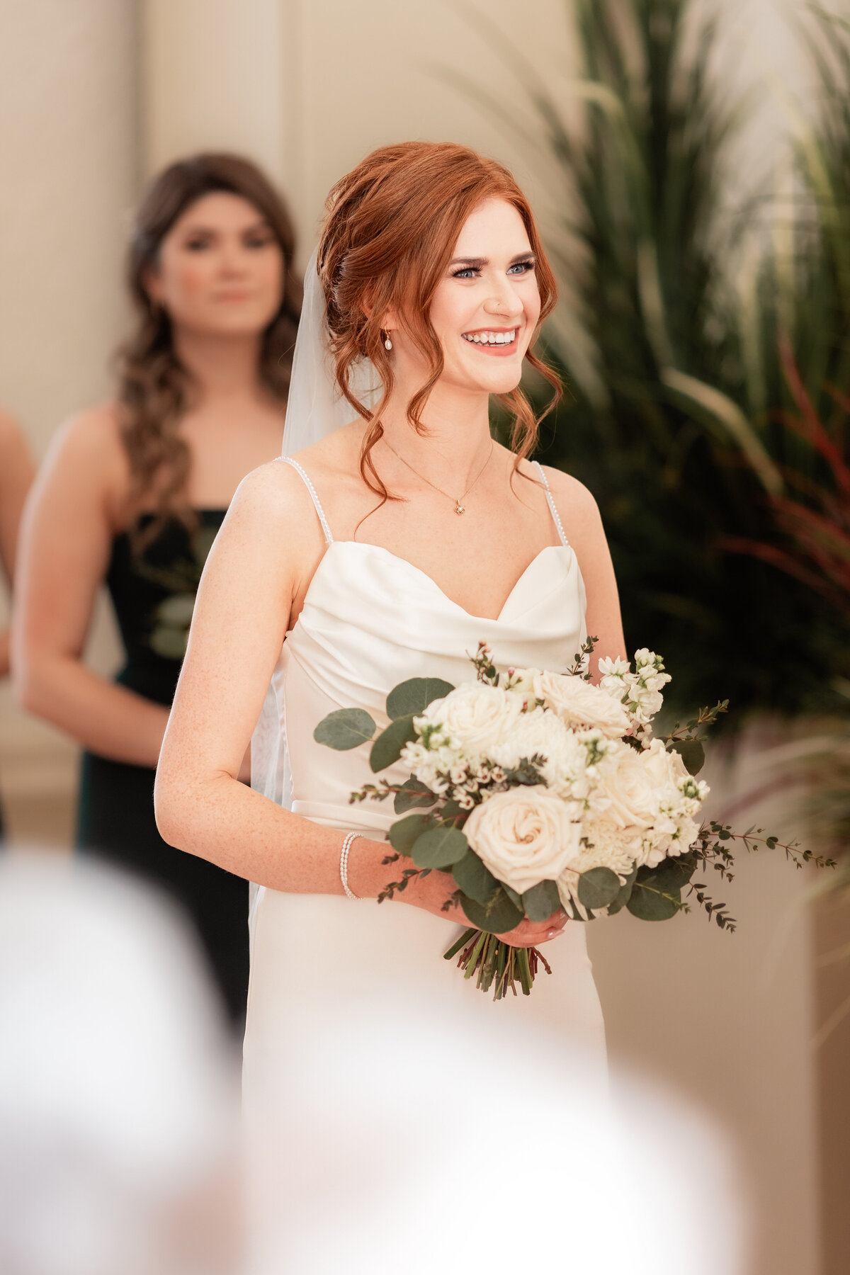 Bride smiles during her indoor winter ceremony
