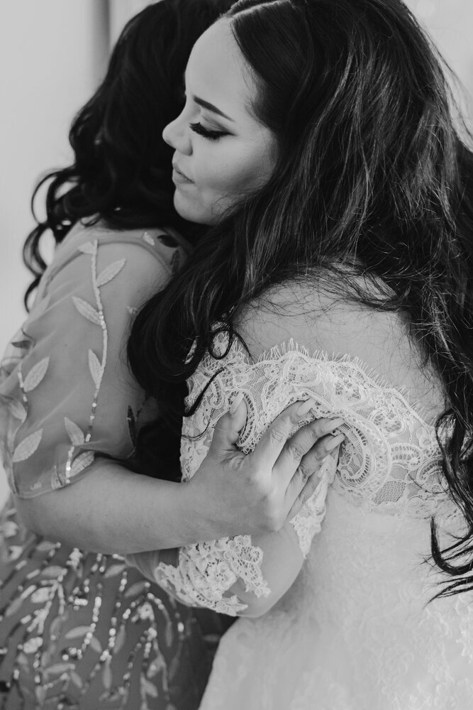 mother-daughter-hug-emotional-wedding-moment-ashton-hill-farm-cedar-rapids-iowa-storyteller-collective-photo-co