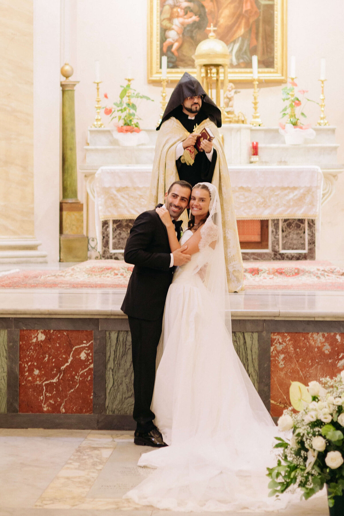 Priest blessing the couple during wedding ceremony in Rome

