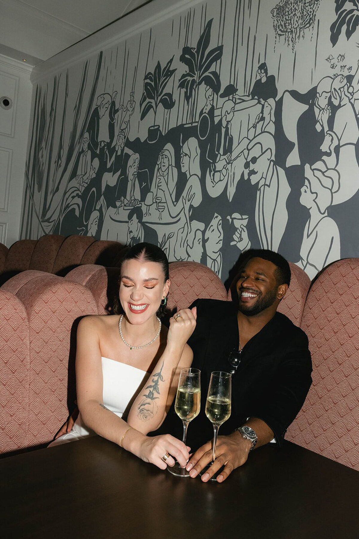 film engagement photography in orlando with couple sitting with drinks