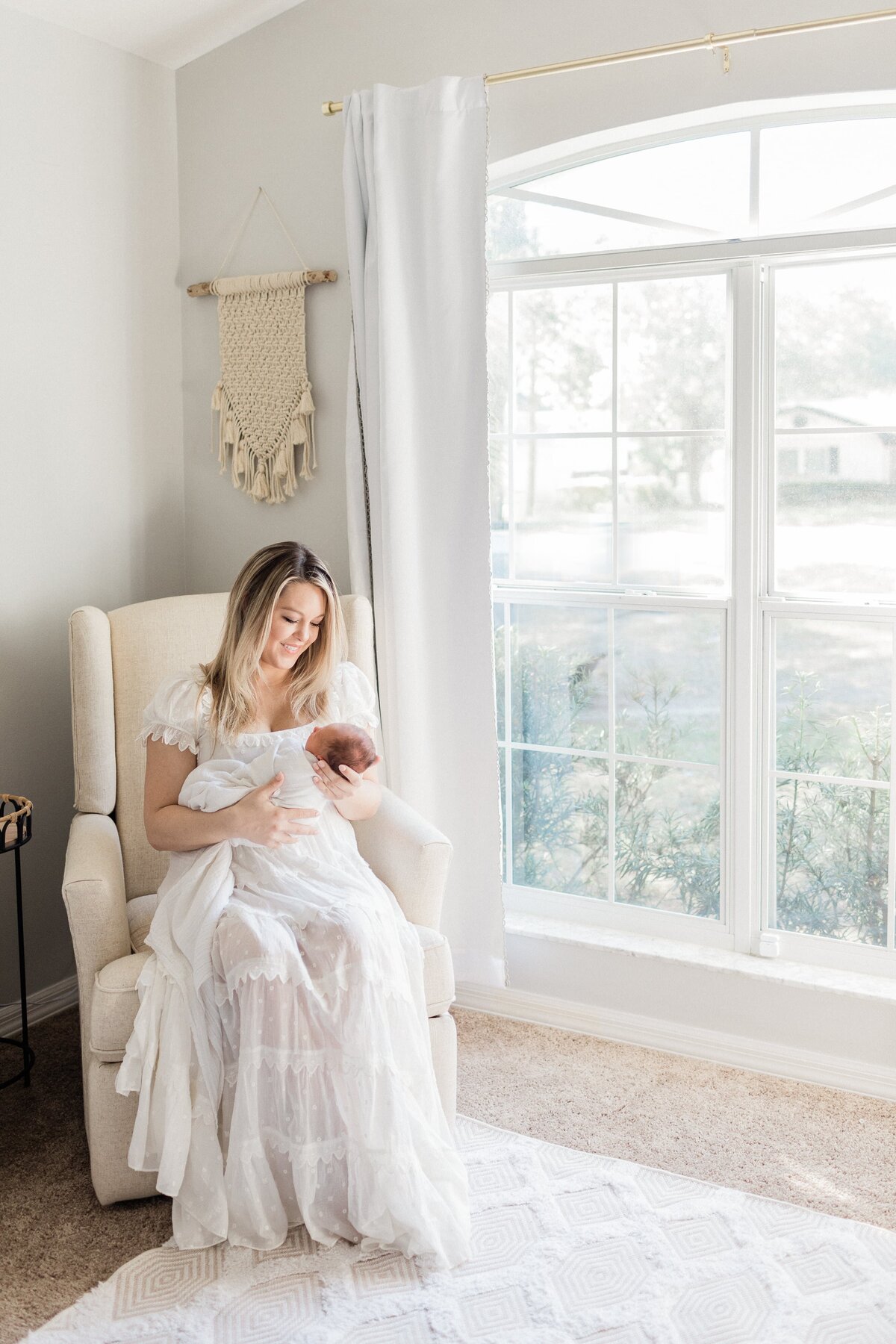 mom and baby in the nursery with Orlando in-home newborn photographer