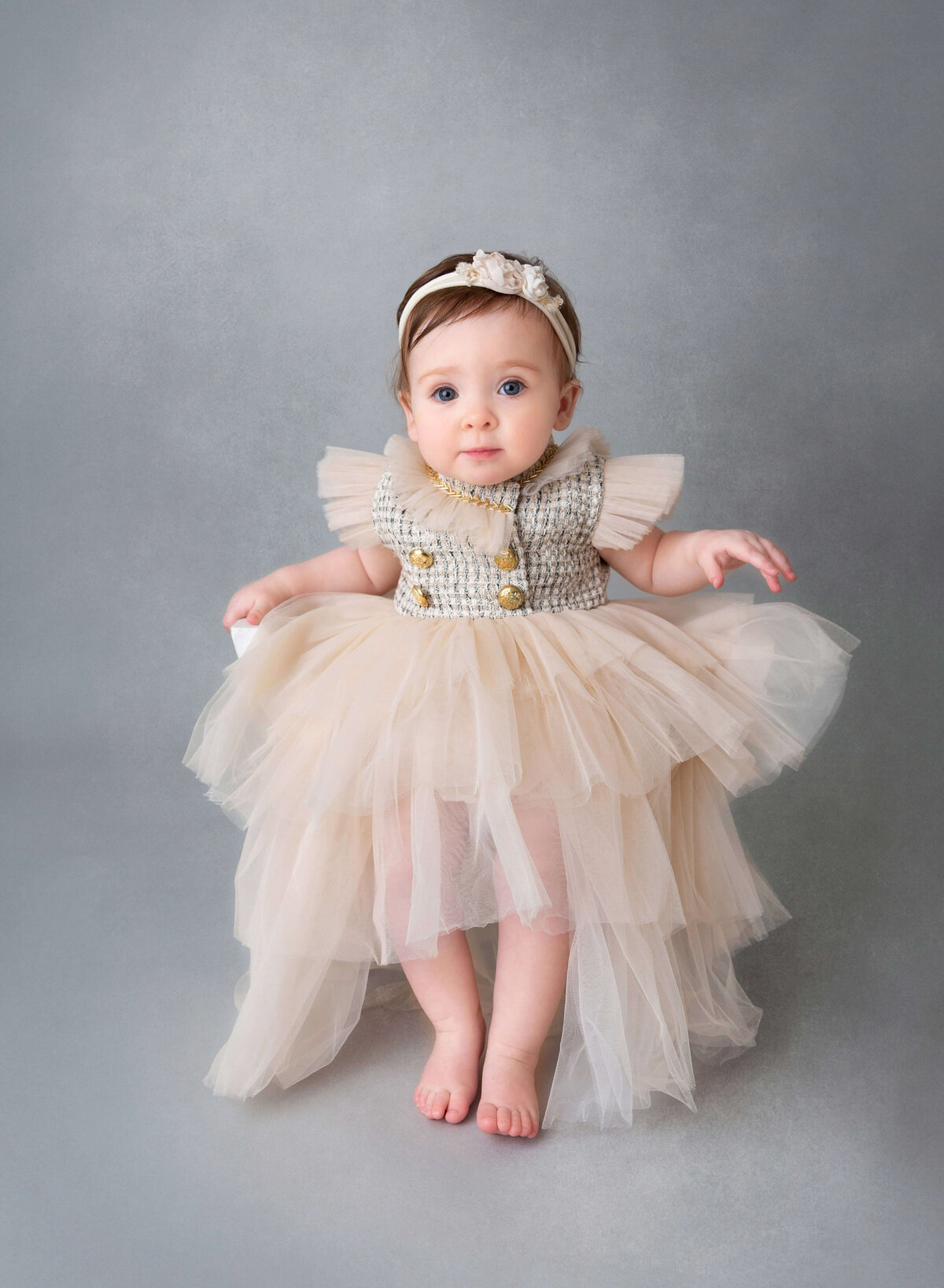 NYC baby photography studio baby girl in tulle dress poses for her 1st birthday photoshoot