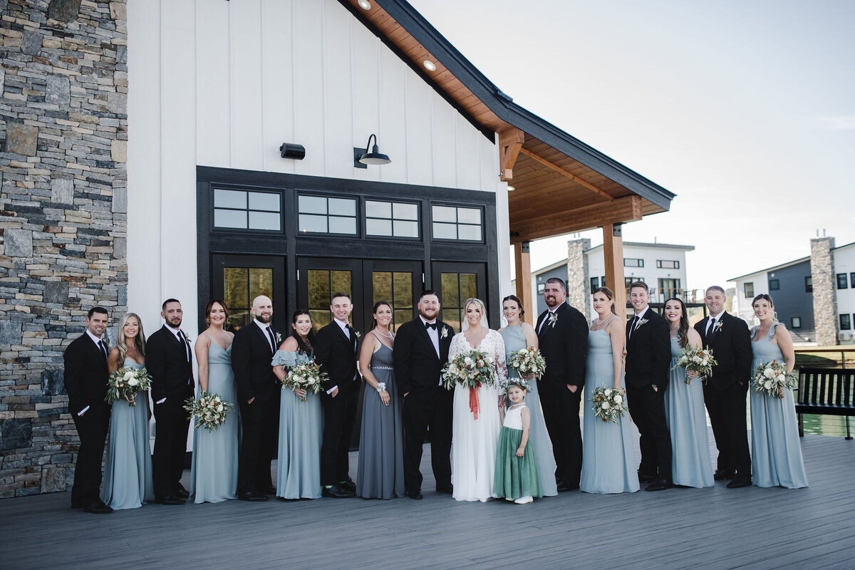 Bridesmaids and groomsmen standing together with bouquets