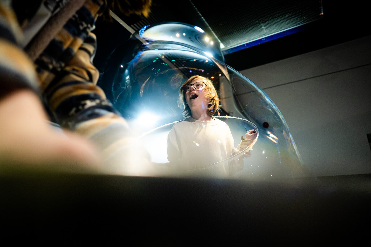  a man reading a magazine outside a motorhome with his feet up