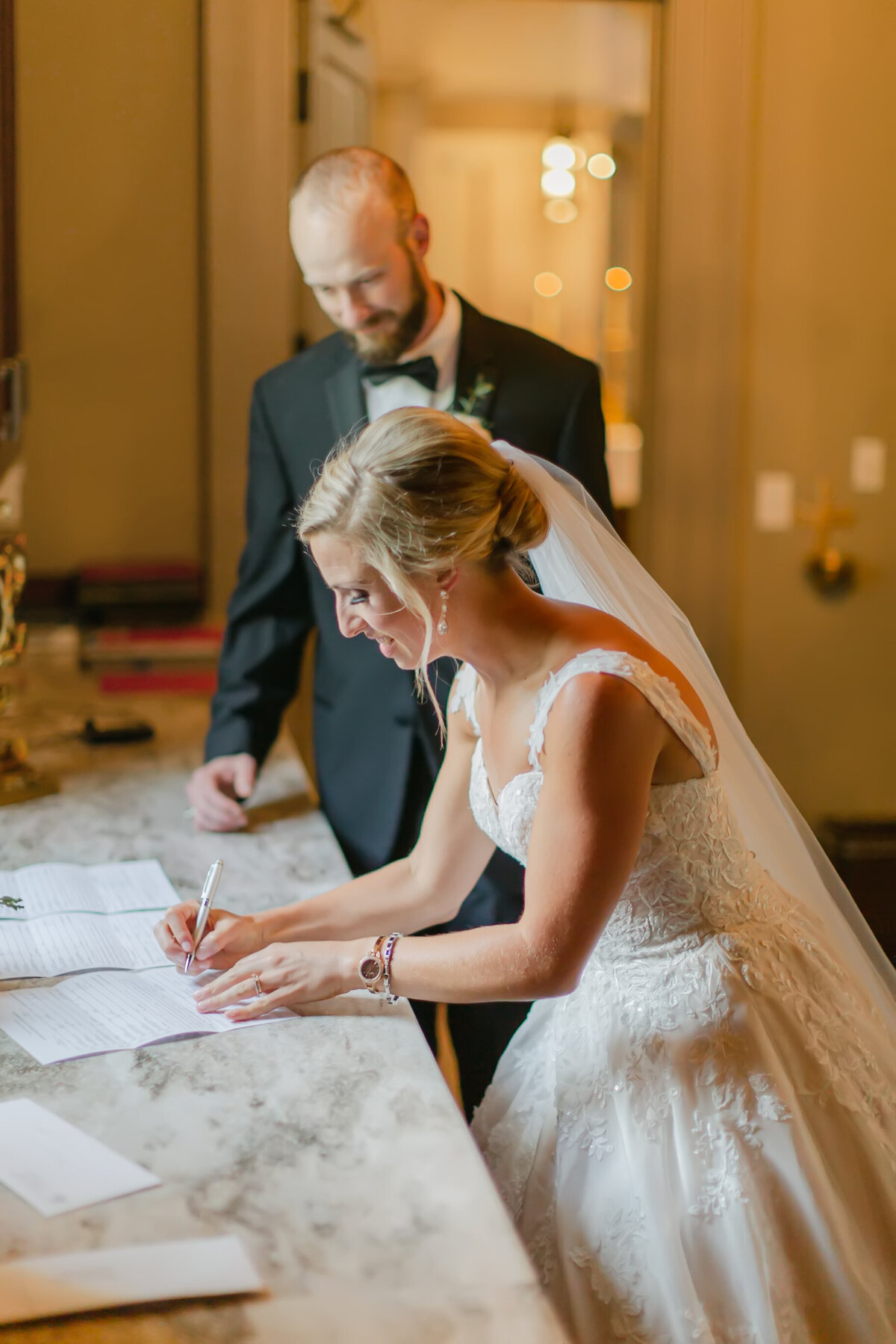 bride and groom signing marriage license after ceremony