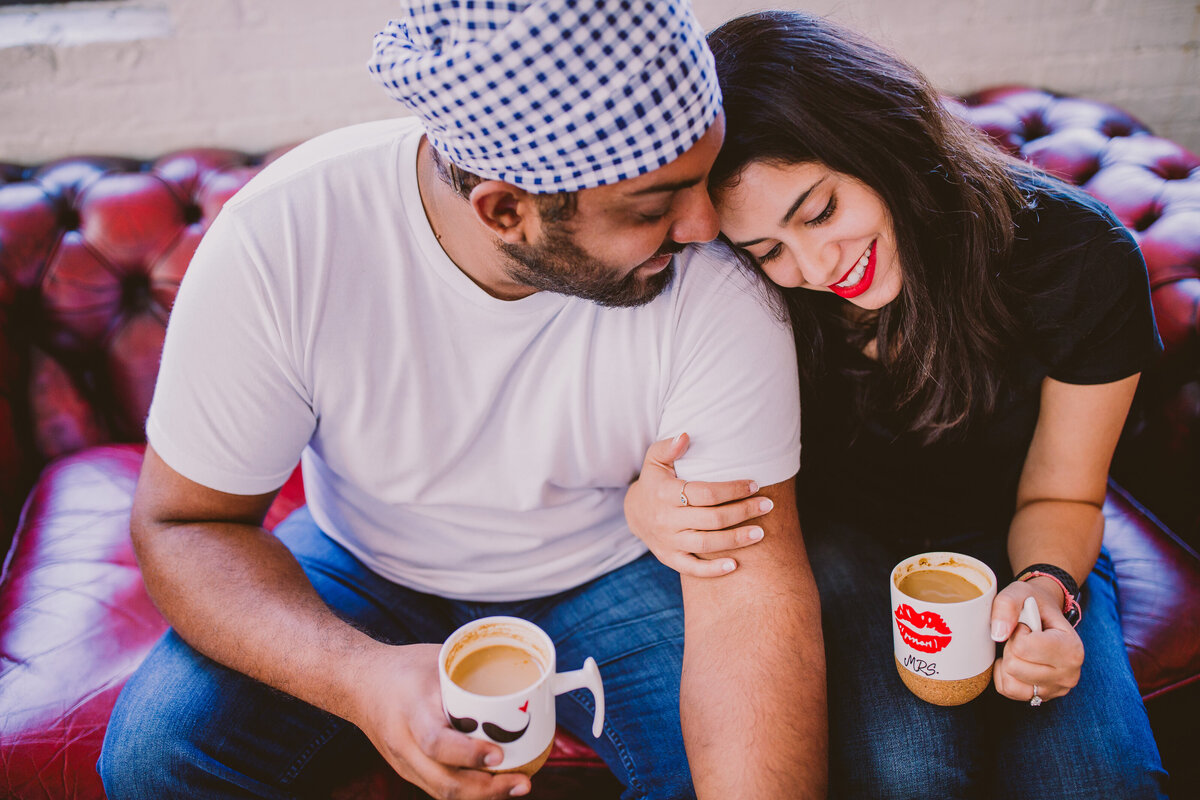 A couple having a coffee sitting down with Mr. and Mrs. cups in brooklyn nyc roasters