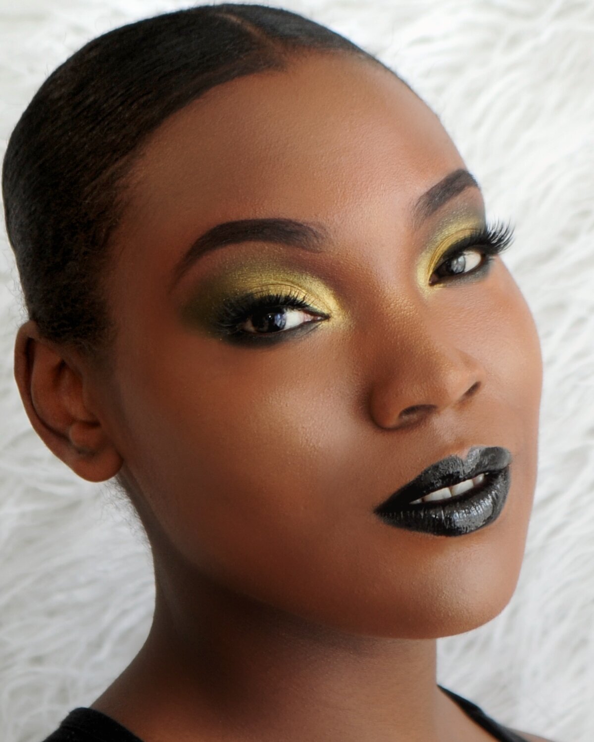 Bold glam look with gold shimmer eyeshadow and black lip by Jessica, makeup artist in CT.