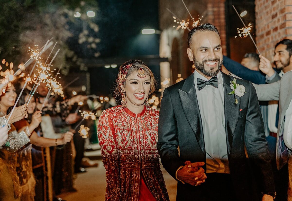 Coupe smiles as their wedding comes to a close after their wedding grand exit with sparklers at the Bowery House and Gardens.