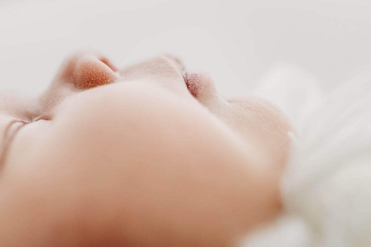 Close up detail image of newborn baby lips and cheeks