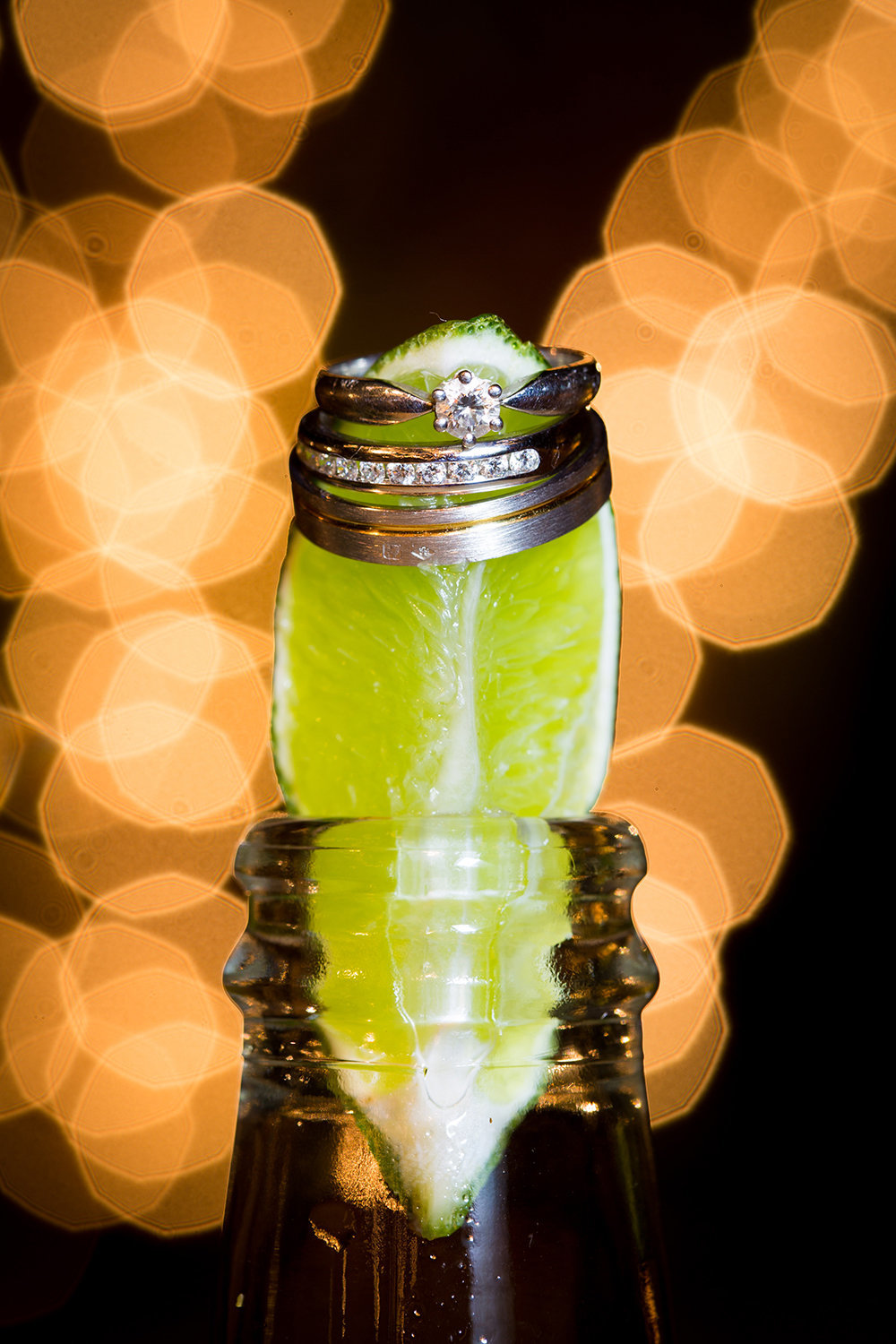 wedding photos close up with ring on a wine glass