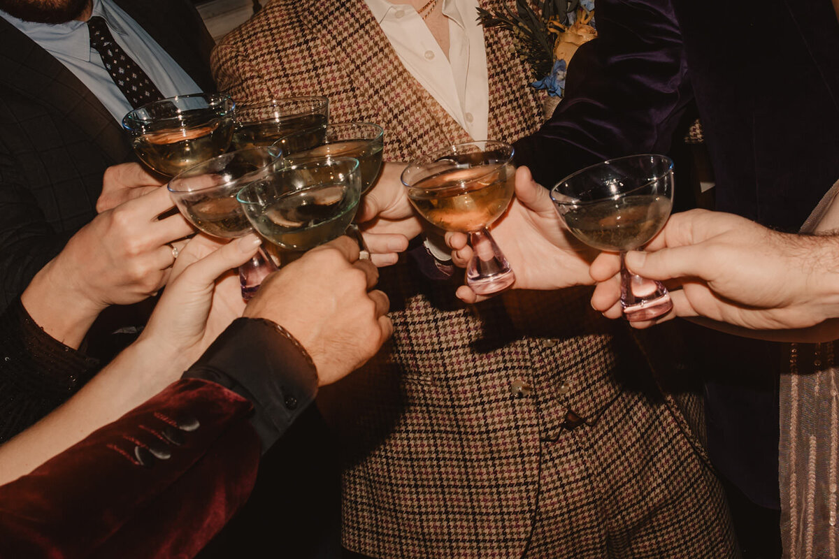 A group of people holding glasses to toast 