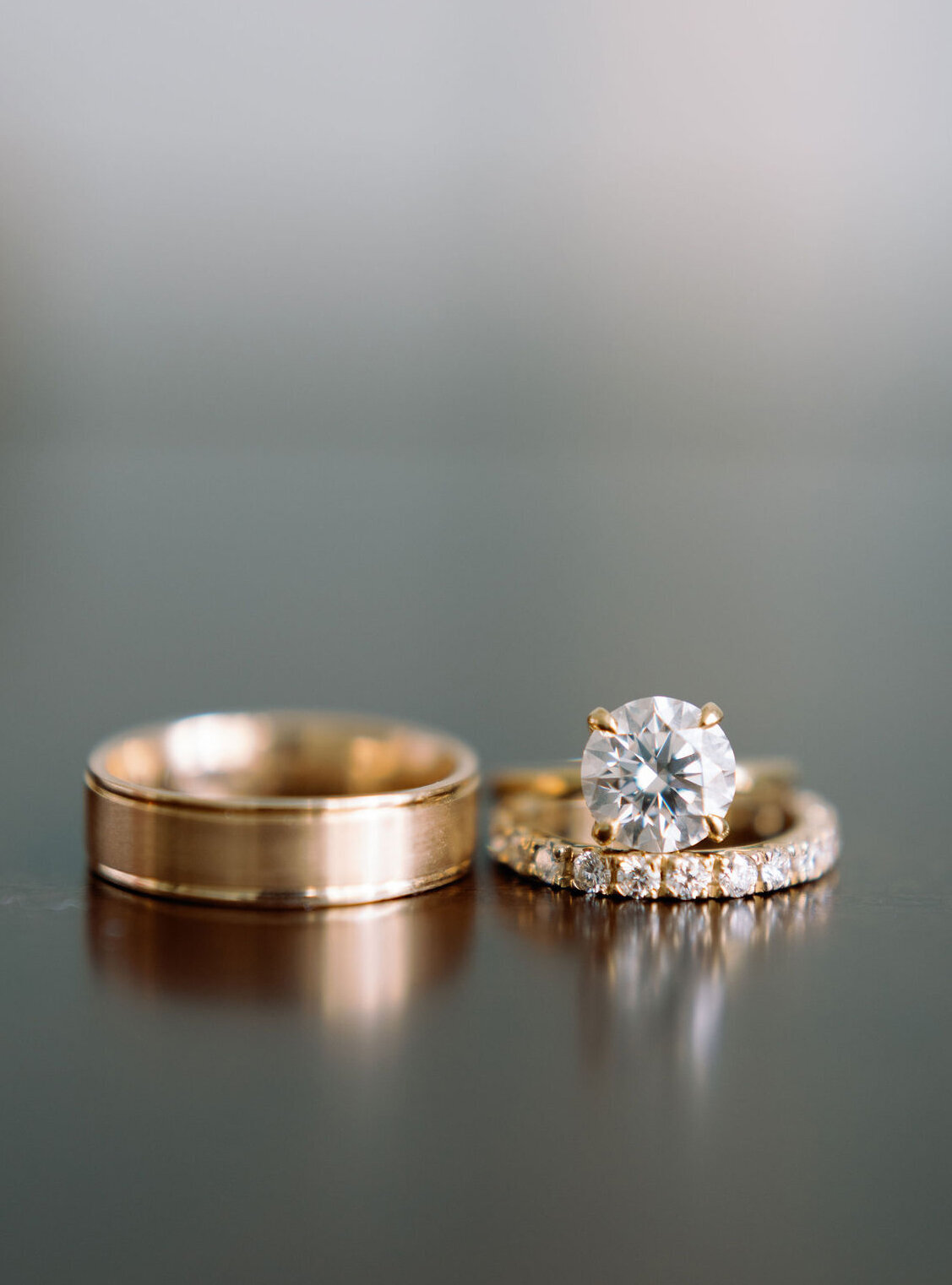 Close up of a wedding band and diamond ring. 