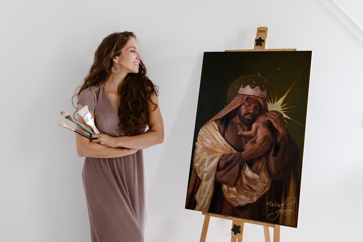 artist smiling with artwork