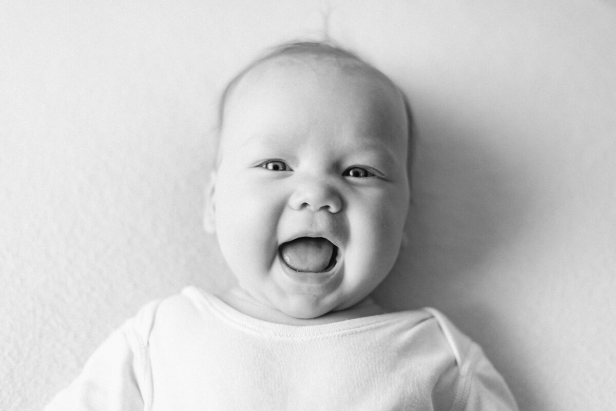 baby girl smiling at milestone photoshoot in Billingshurst