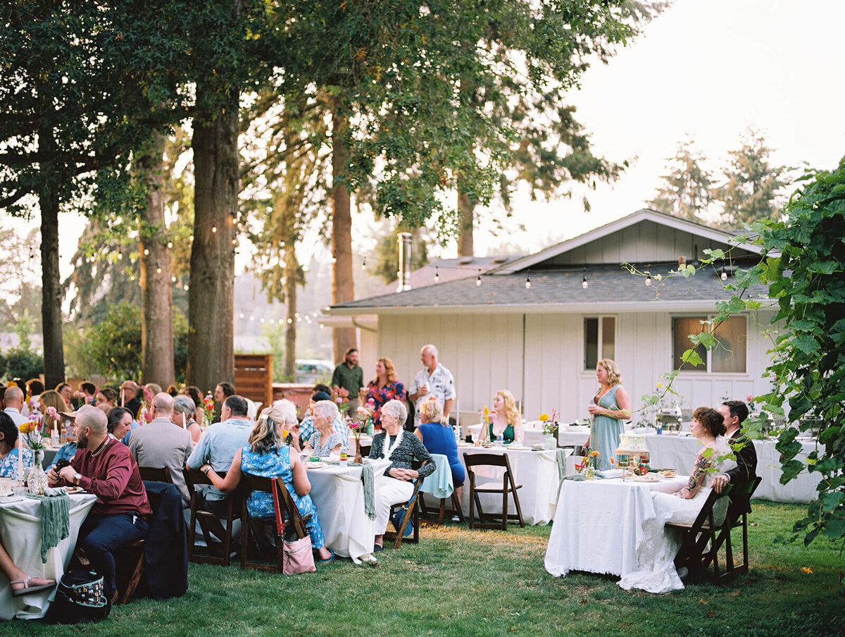 Outdoor wedding reception in a backyard captured on film. 