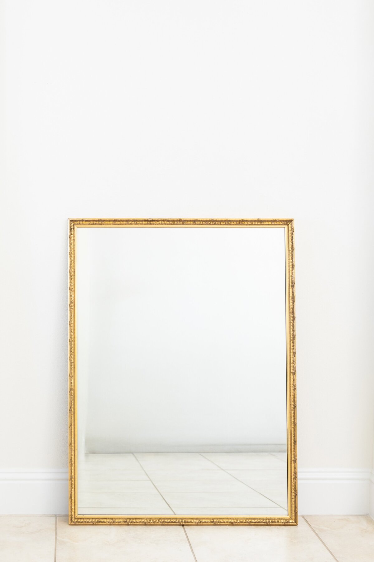 Large gold mirror with ornate border 