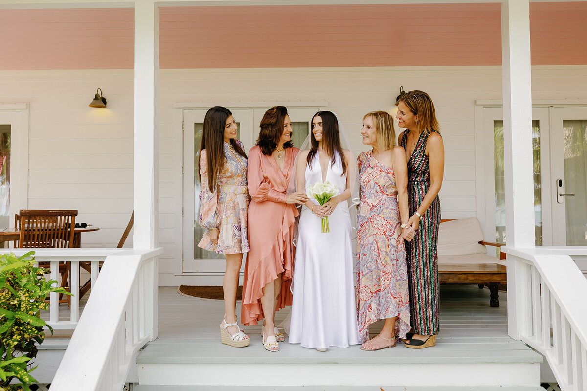 Minette shares a joyful moment with her bridesmaids before the ceremony at Casitas at Cheeca. Florida Keys micro wedding captured by Claudia Amalia Wedding Photography.