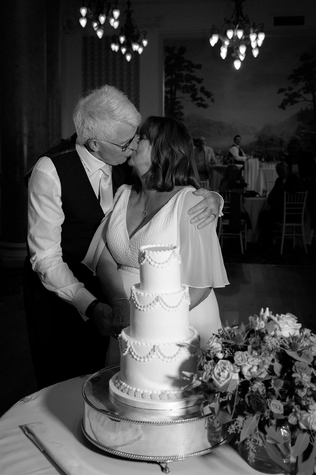 Edinburgh wedding, Balmoral, Cake cutting with the couple kissing.