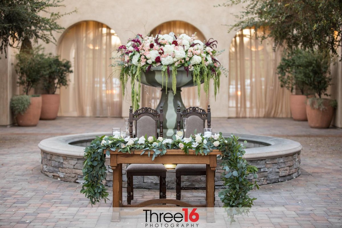 Sweetheart Table setup in front of the water fountain