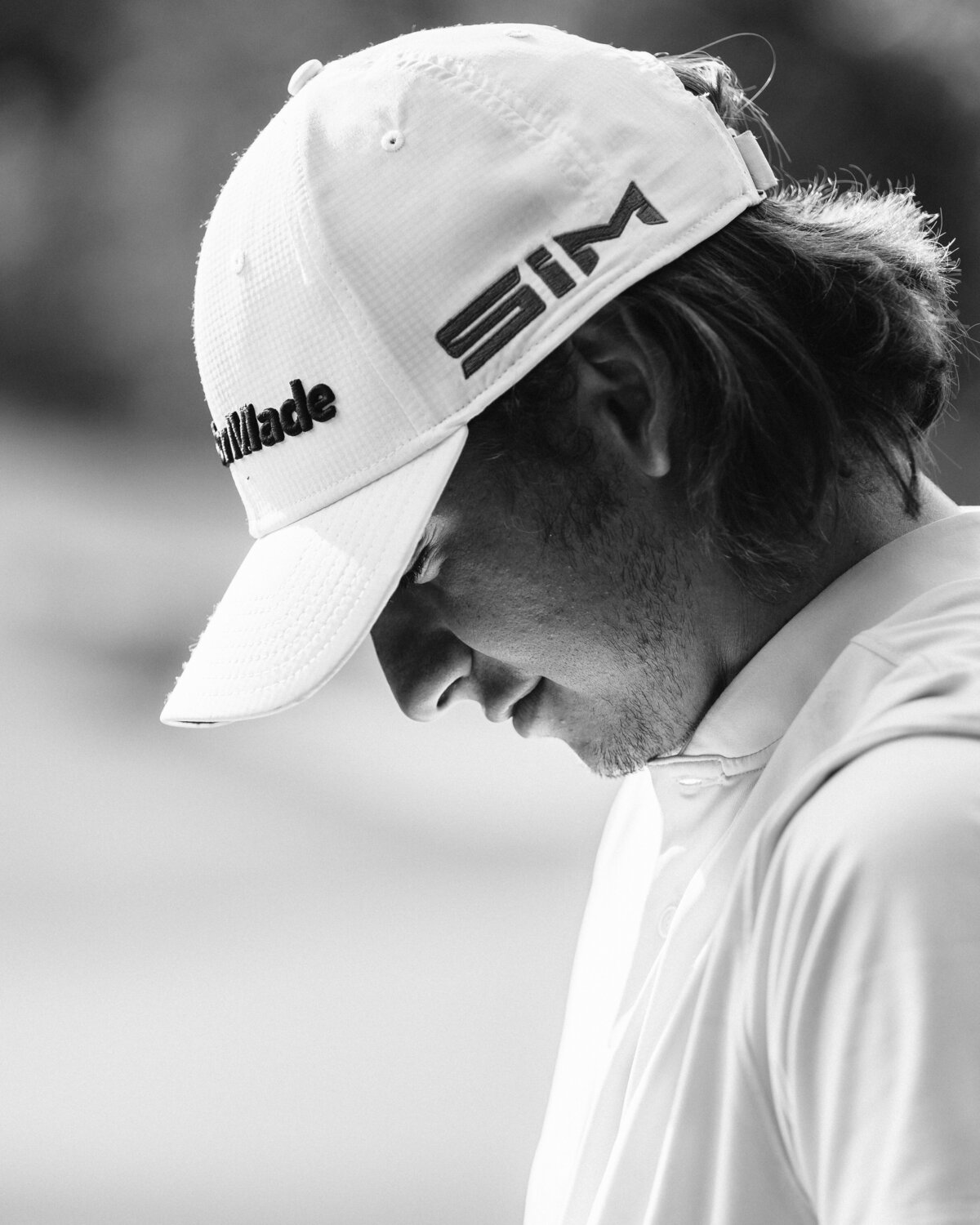 Closeup of golfer breathing before his next shot at Tobacco Road in Sanford, NC. Photo is black and white and shows a lot of emotion on golfer's face.