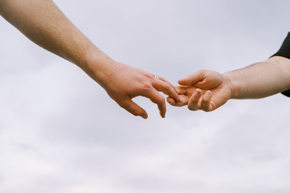 holding-hands-under-blue-sky
