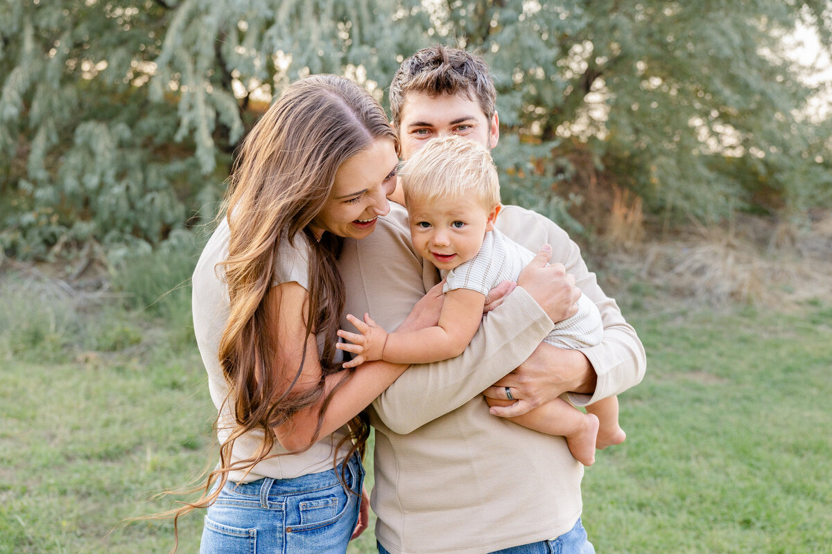 A sweet moment between parents and their young child, full of warmth and joy.