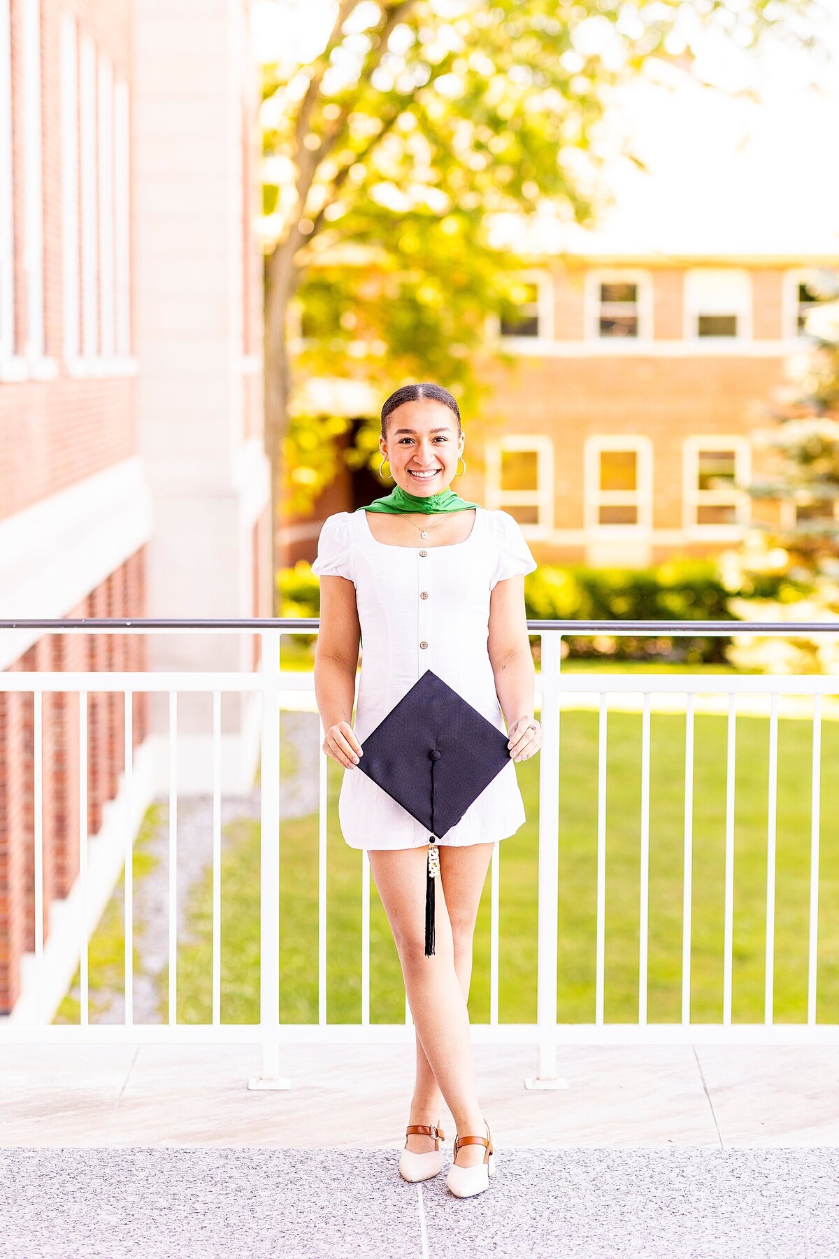 Graduate portrait in Charleston, SC with cap and gown highlighting natural personality and milestone celebration