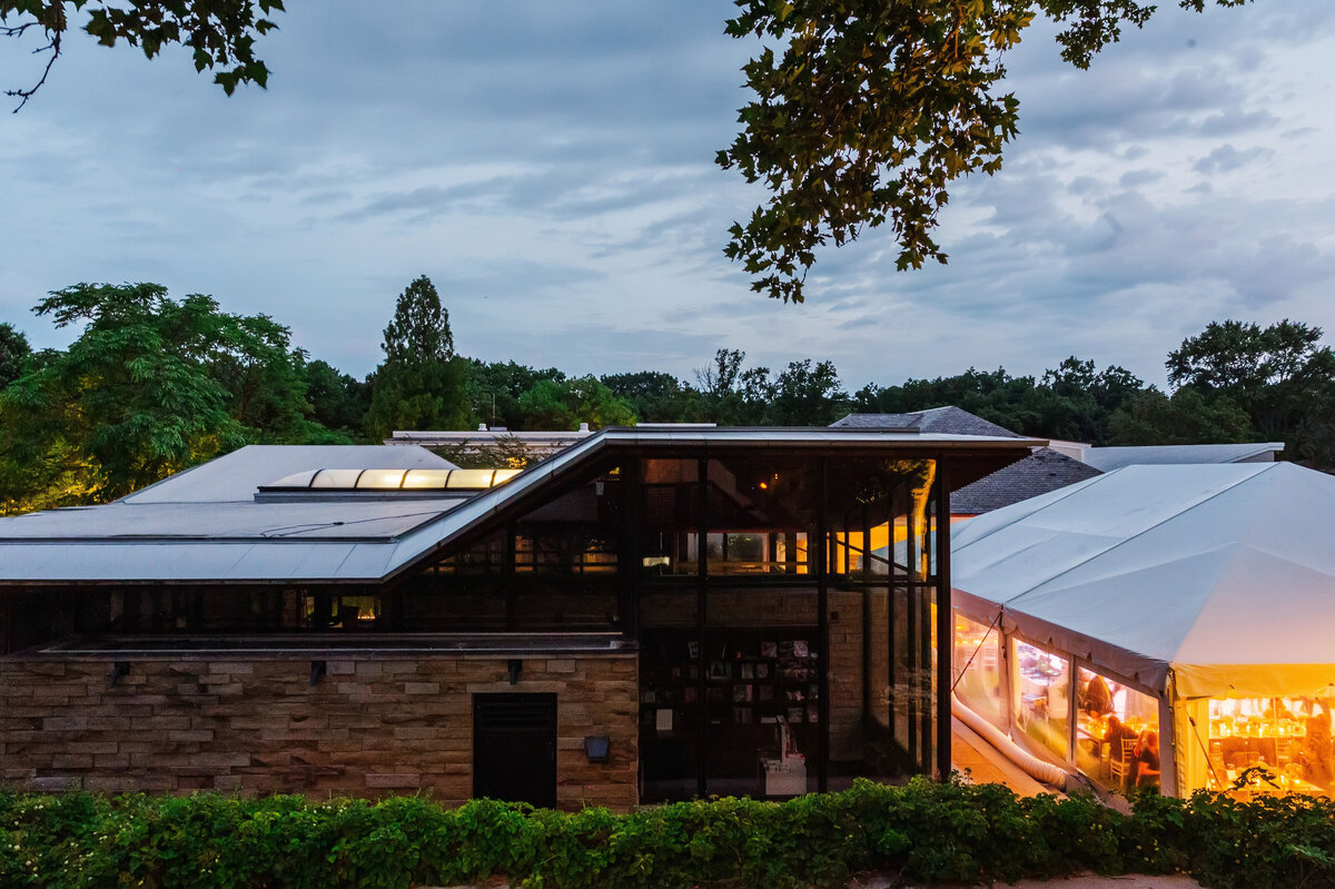 Frick Museum visitors center in the evening light with a party wedding tent setup next to it in pittsburgh