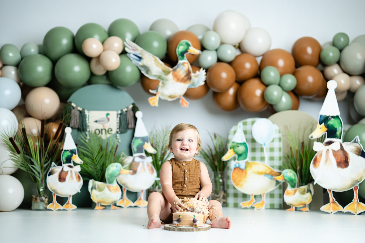 Baby boy with mallard duck themed first birthday cake smash in Canton GA studio