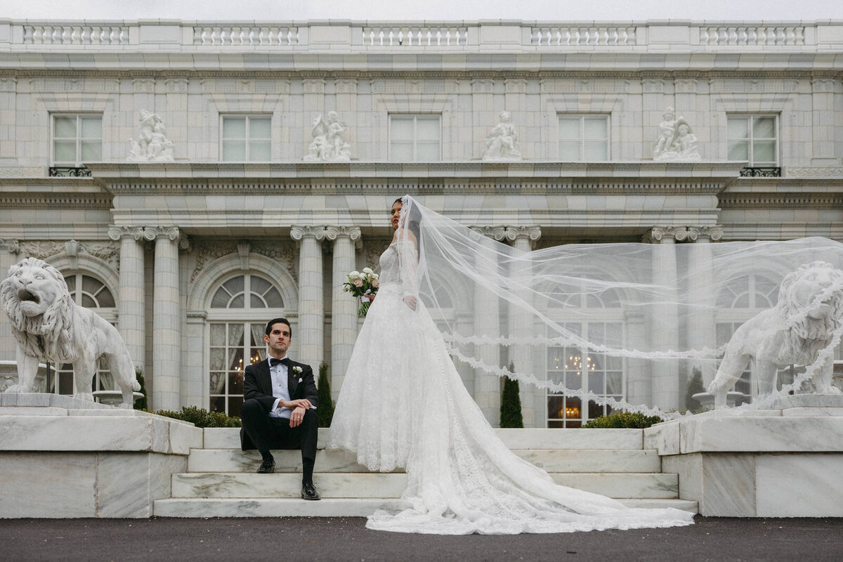 Bride and Groom standing in front of the Rosecliff Mansion in Newport Rhode Island for their wedding day portraits, documented by Andrea-Marie Photography
