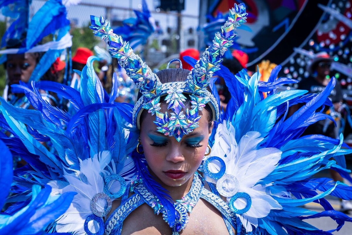 Toronto caribbean carnival parade masquerader in costume with Sunlime Mas, the number 1 medium size band at Toronto Carnival.