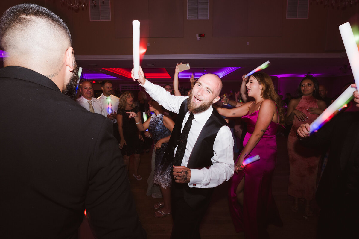 groom having a good time on wedding dance floor
