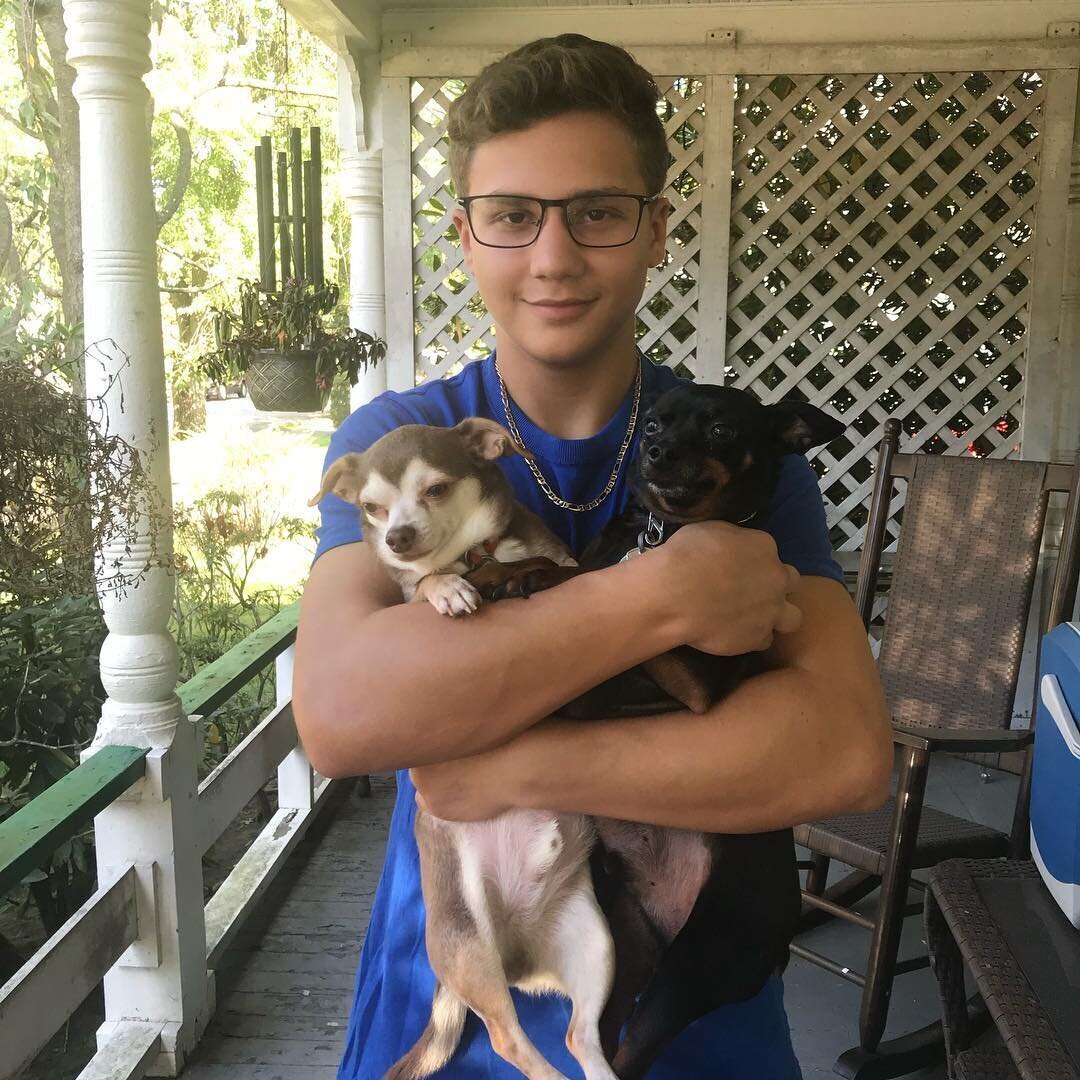 Alex Kaplan family photo holding small dog on about page New Jersey wedding photographer